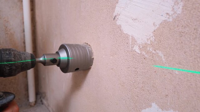 Safely create a hole in drywall or concrete wall. Using laser tools to expertly cut perfect holes in walls. Laser-assisted precision drilling to install pipes in textured plaster walls