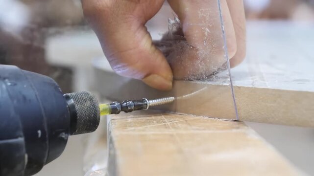 Marking cut lines on wood surface with a pencil