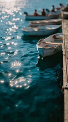 Fototapeta premium Gentle sunlight dances on calm, blue waters while small moored boats lined along the pier create a serene scene.