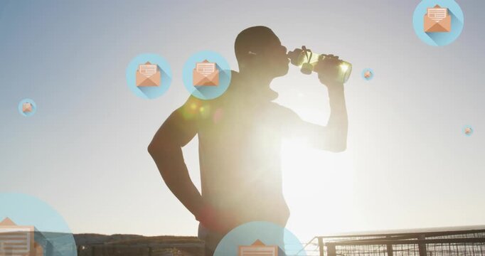 Animation of letter in open envelope icons, african american athlete drinking water during practice