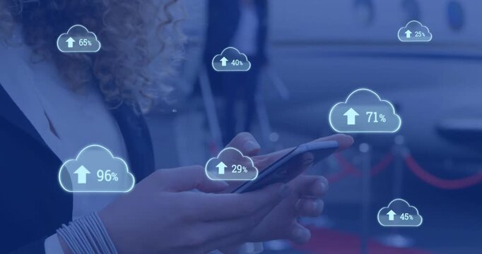 Animation of clouds with percents and arrows over caucasian businesswoman using smartphone
