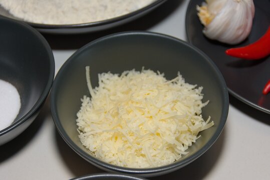 Shredded White Cheese in Black Bowl for Cooking Preparation