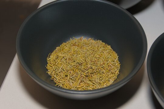 Dried Rosemary Leaves in Black Ceramic Bowl