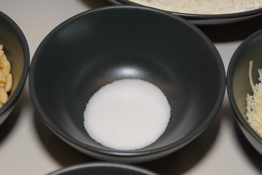 White Table Salt in Black Ceramic Bowl