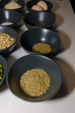 Fresh Cooking Ingredients in Black Ceramic Bowls on White Counter