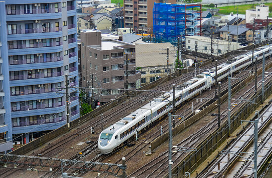 Railway tracks with an electric train passing through in Kanazawa, Japan.