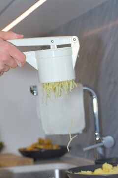 Ricing Cooked Potatoes Onto Flour for Gnocchi Preparation