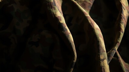 Closeup textured detail of folded camouflage fabric showing intricate patterns and folds