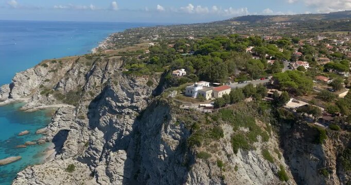 Aerial view of Capo Vaticano, located on the Coast of the Gods, in Calabria, southern Italy. It is a high rocky promontory with a lighthouse at the summit overlooking the Mediterranean Sea.
