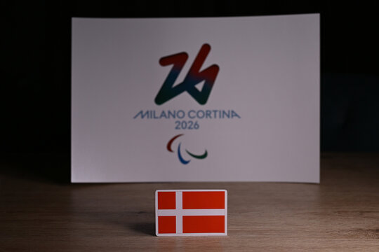 February 9, 2026. Milan, Italy. The flag of Denmark on the background of the logo of the XIV Paralympic Winter Games and generally referred to as Milano Cortina 2026