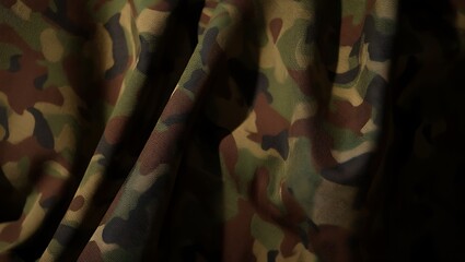 Textured military camouflage fabric with deep folds and shadows creating a sense of depth and realism