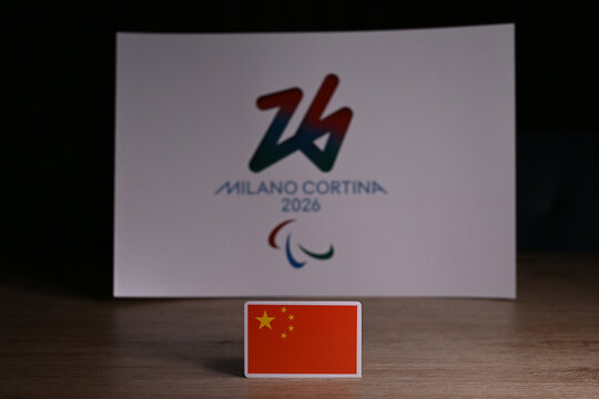 February 9, 2026. Milan, Italy. China flag on the background of the logo of the XIV Paralympic Winter Games and generally referred to as Milano Cortina 2026