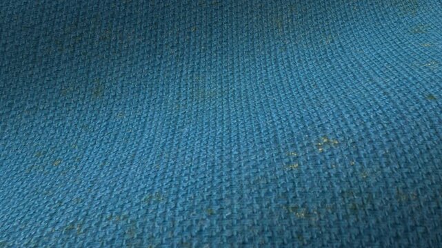 Vintage slate-blue fabric texture waves with aged tones and even weave