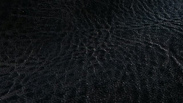 Smooth black leather texture waves with fine embossed grain