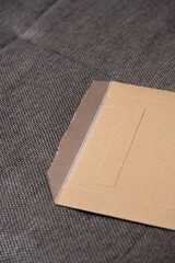A brown envelope is sitting on a gray cloth