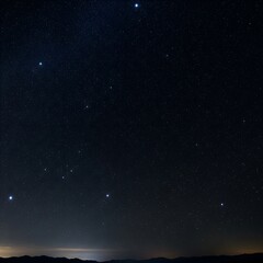 Fototapeta premium A breathtaking night sky filled with stars over a mountain range at dusk