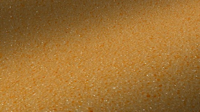 Light tan synthetic foam texture waves with fine uniform grain