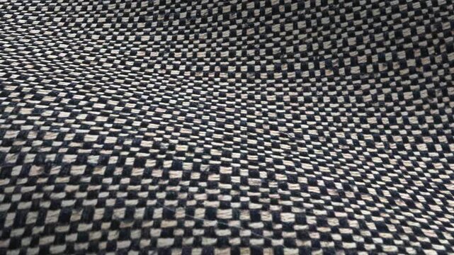 Dark gray woven textile waves of texture and mottled pattern