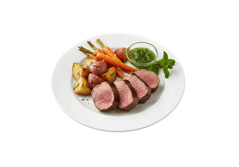 A plate with three slices of medium-rare lamb, baked red potatoes, and carrots, along with a small bowl of green mint jelly and a sprig of mint. Isolated on white.