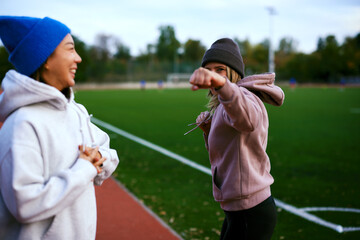 Playful boxing move during outdoor fitness warm up