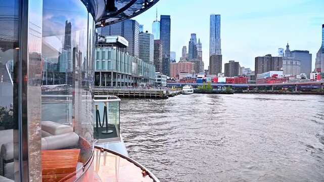 Travelling by the riverboat on the gloomy day. Footage from the board of the boat distancing from the pier of New York, USA.