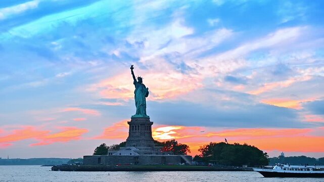 Riverboat moves by the waterscape in New York Harbor. River tour near the Statue of Liberty at sunset time.