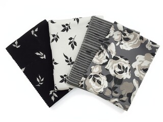 Three fabric swatches with floral patterns in black and white