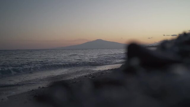 Scenic view of mount etna volcano from the beach at sunset