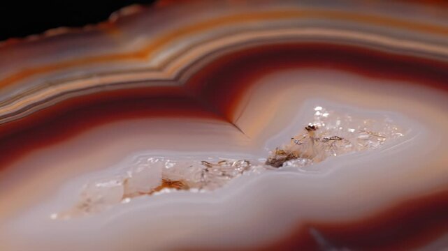 Macro Close up of a Polished Agate Slice Showing Concentric Bands of Red Brown White and Orange Colors with a Crystal Geode Cavity Detailed Texture Natural Stone Slice Macro Photography