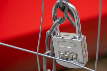 lock with code number and chain on a metal fence