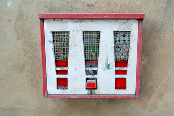 Old gumball machine on a wall