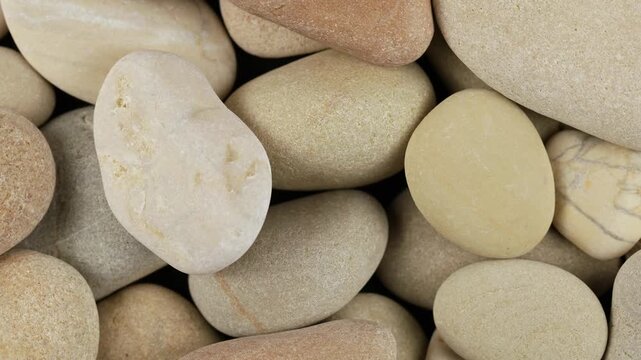 Sepia brown pebbles rotation background texture. Loop motion