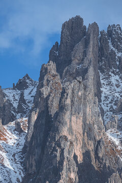 Dramatic winter view of Grignetta spires emerging from thick fog and low clouds. Moody alpine landscape with snow-covered rocky peaks in the Grigne mountains, Lecco, Italy - January 2026