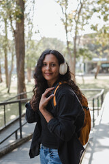 Fototapeta premium Woman student with headphones enjoying outdoor learning