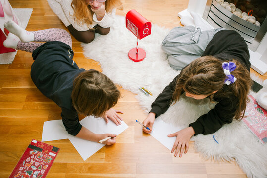 Kids Drawing Letters for Santa Claus at cozy Home 