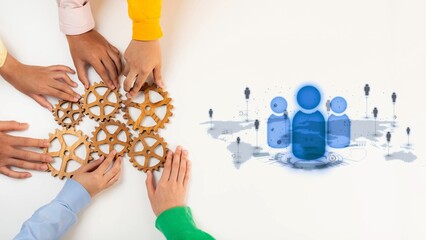 Obraz premium This image captures hands assembling gears, symbolizing teamwork and innovation. The digital elements represent modern communication tools essential for collaboration. Raster