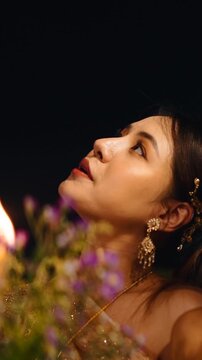 Beautiful thai woman praying during loi krathong festival