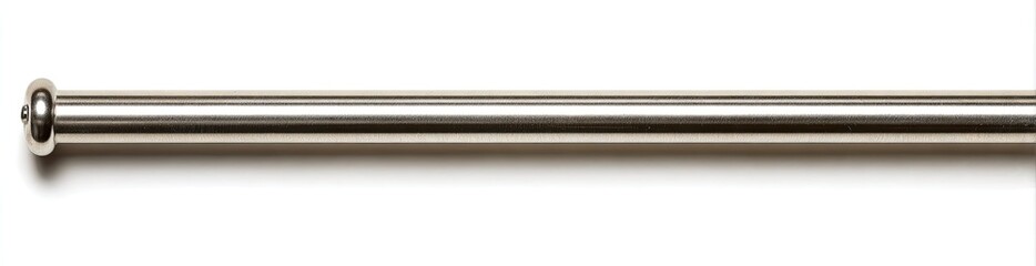 A thin, metallic rod with a rounded end sits on a white background, casting a soft shadow