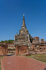 Fototapeta premium Ancient Buddhist Temple Ruins and Buddha Statues in Ayutthaya, Thailand