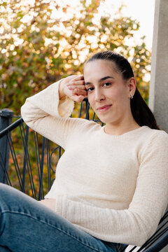 girl sitting on an outdoor chair