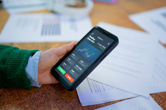 Business professional checking financial data on smartphone