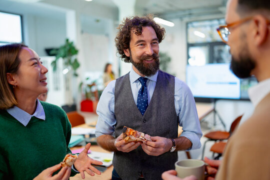 Coworkers enjoying food during office break