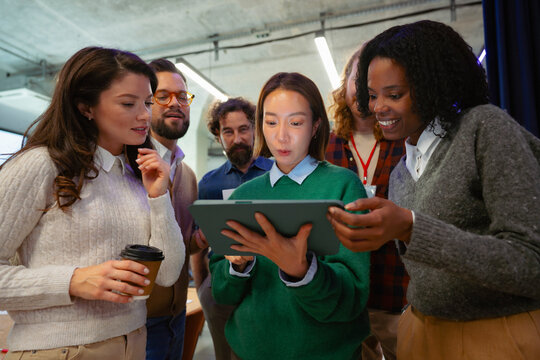 Group looks at tablet in office
