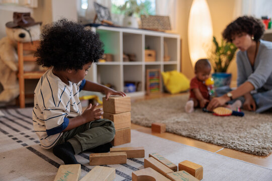 Children playing with blocks and toys in a playroom.