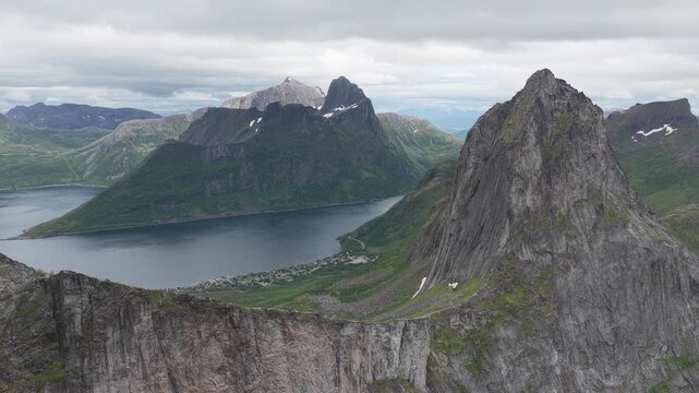 Aerial, drone flight, impressive Segla and Hesten cliffs and mountains on Senja island, rainy summer day. Amazing outdoor travel destination, hiking area in Norway. Wild nature in arctic Norway. Impre