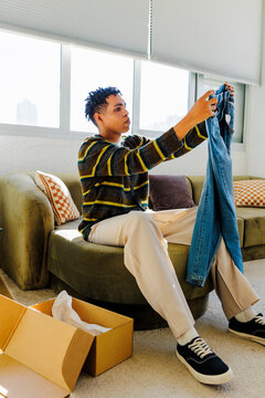 Man unpacking new clothing from delivery box