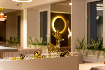 Festive restaurant interior detail with sparkling golden reindeer decoration