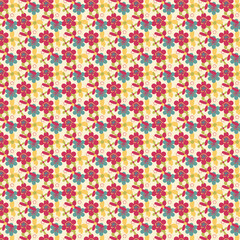 Colorful seamless floral pattern with red, yellow and teal flowers. Cheerful retro design ideal for wallpapers, fabrics and decorative projects.