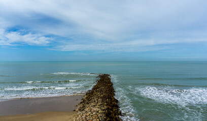 Scenic Stone Breakwater Extending into the Atlantic Ocean in Cadiz Spain © photoopus
