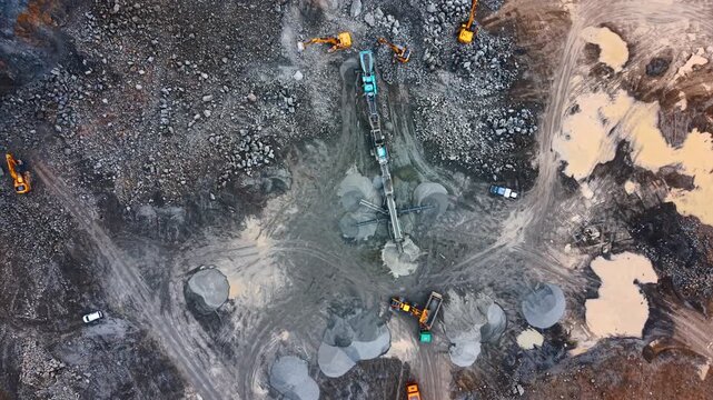 Machinery at work on-site. Heavy machinery operates on a construction site. Trucks and equipment work together to move materials and reshape land.